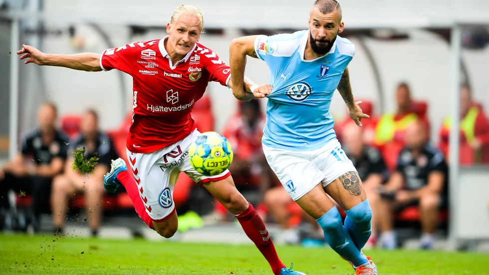 Henrik Löfkvist (i rött) i kamp med Malmö FF:s Guillermo  Molins. 