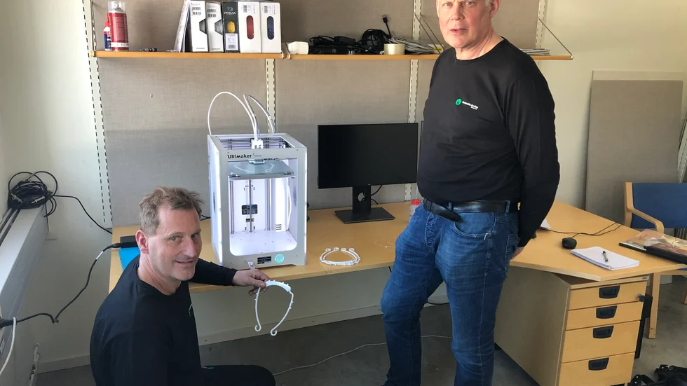 Robert Svartling, t v, och Roger Lindberg på företaget Composite Service, vid 3D-skrivaren som just nu används till framställning av visirskalmar.
