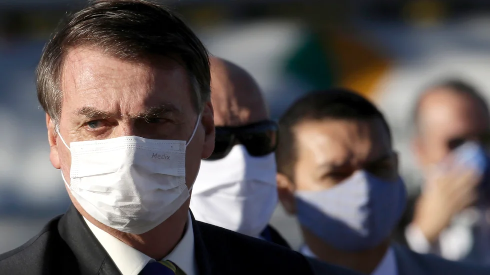 Brasiliens president Jair Bolsonaro med munskydd. Tidigare i veckan dömdes den coronaskeptiske presidenten av en domstol att bära munskydd när han rör sig i offentliga sammanhang, annars väntar böter.