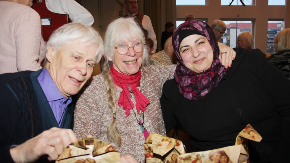 Johnny Brandt, Birgitta och Elham Ashkar uppskattar julgransplundringen. Elham som är från Syrien är med på julgransplundring för första gången. 