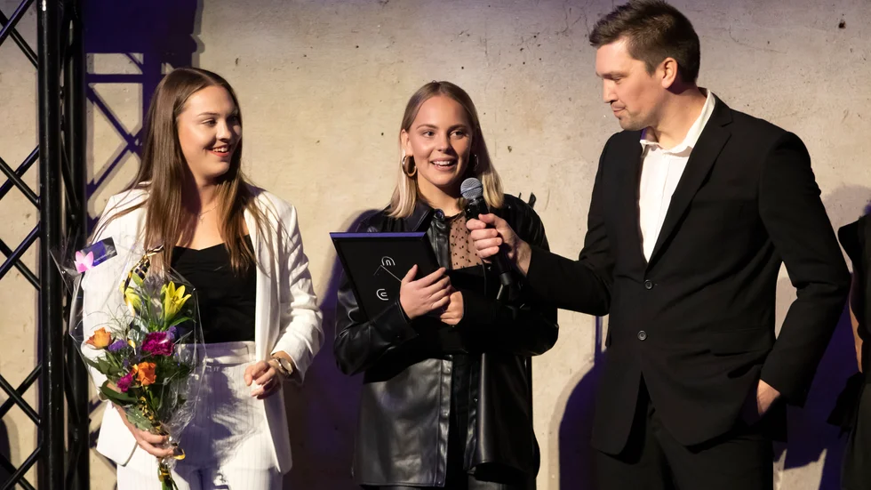 Märta Säfström och Agnes Nyberg tar emot UNT-guldet av tidningens sportchef Mathias Rutegård.