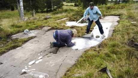 Roger Wikell och Kenneth Ihrestam arbetar med att dokumentera onsdagens fynd vid Casimirsborg. De sensationella fynden gör kullen till den märkligaste platsen i Småland när det gäller hällristningar.