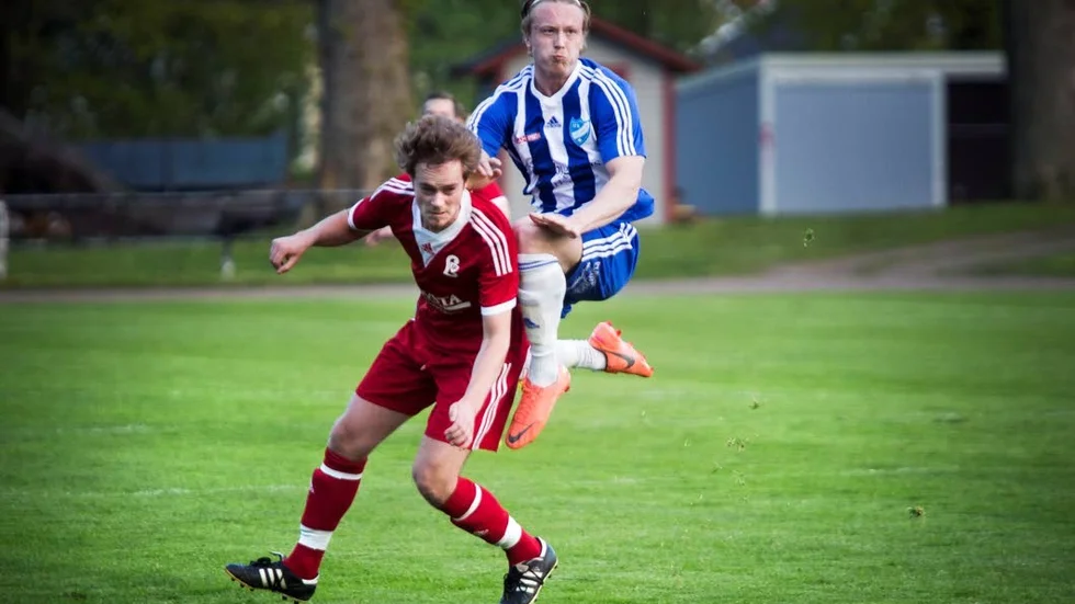IFK Västerviks Joel Kronståhl Karlsson (blå) i kamp med en spelare från Lommaryd.