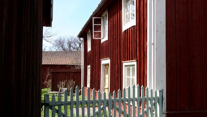 En grind mellan boningshuset och ett uthus gör att gårdstunet känns ombonat. Grinden är målad med oljefärg med zinkgrönt pigment. Det blir allt svårare att få tag i riktiga pigment, zinkgrönt är förbjudet numera, vilket Göran Söderström anser vara en överdriven försiktighetsåtgärd.