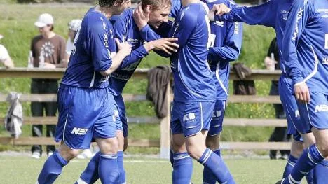 Födelsedagsbarnet Simon Brännström omfamnas av lagkompisarna efter sitt 3-0-mål mot Robertsfors.