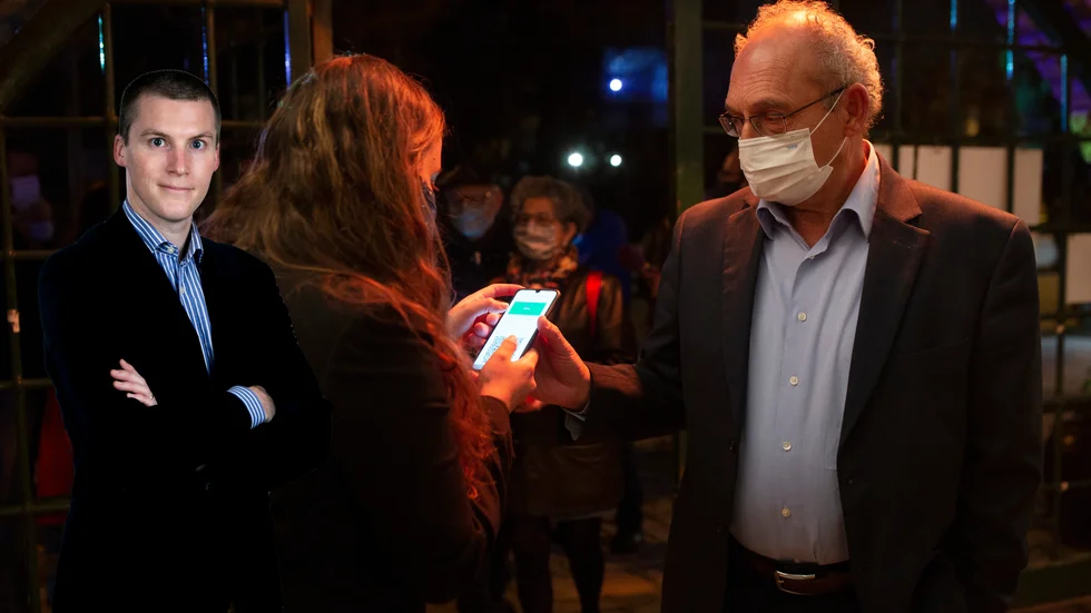 En man visar upp sitt digitala vaccinintyg för att få komma in på en teater i Jerusalem.