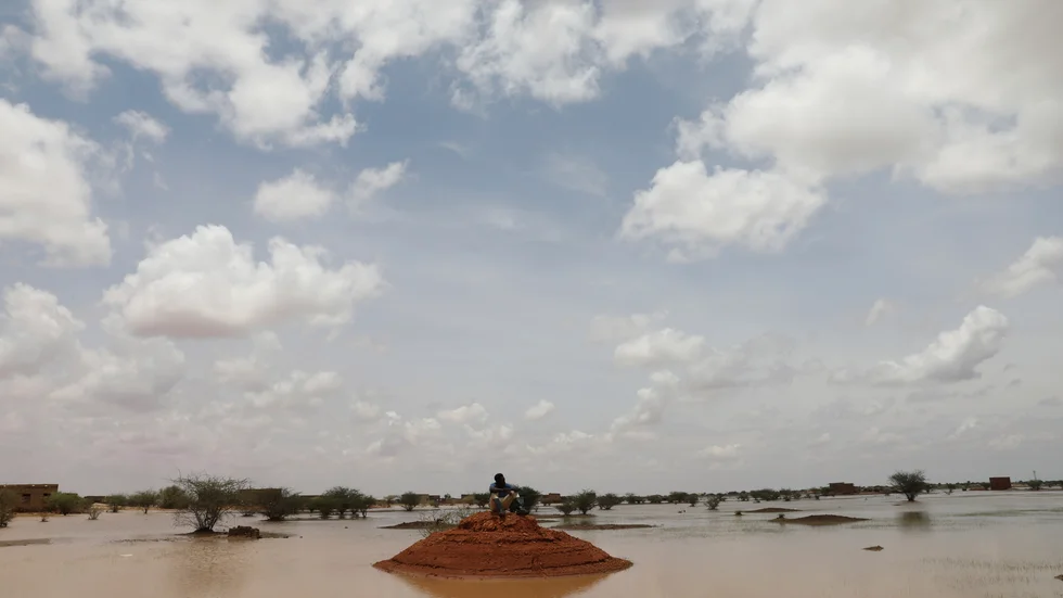 En sudanesisk man blickar ut över översvämningsdrabbade Osaylat, några mil sydöst om huvudstaden Khartum.