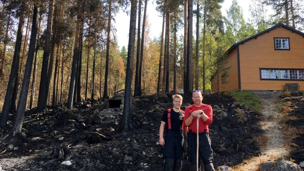 Simon Karlsson och Fredric Tunebäck framför ett av husen som de lyckades rädda i Bräcke.