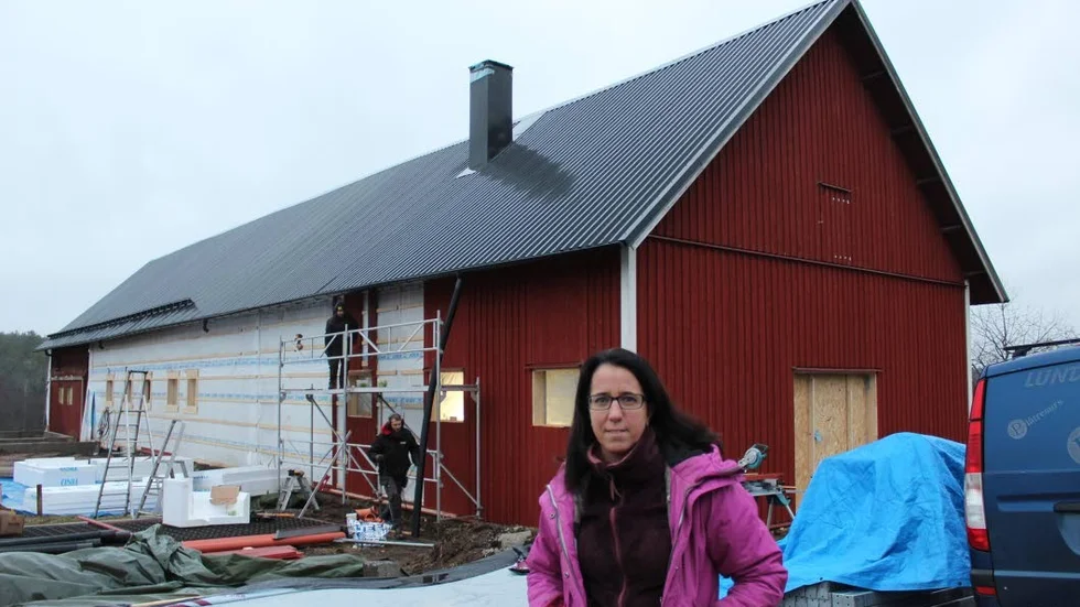 Jennie Norström från styrelsen framför ridskolans stora stall, som nu totalrenoveras.