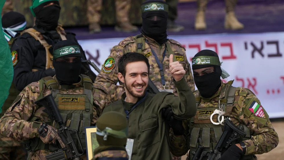 Israelen Omer Shem eskorteras av Hamas innan han lämnas över till Röda korset.