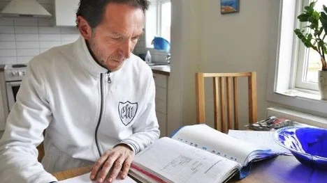 Leif Nyman sitter vid köksbordet och rättar matteprov trots att det egentligen är påsklov och en ledig dag.
