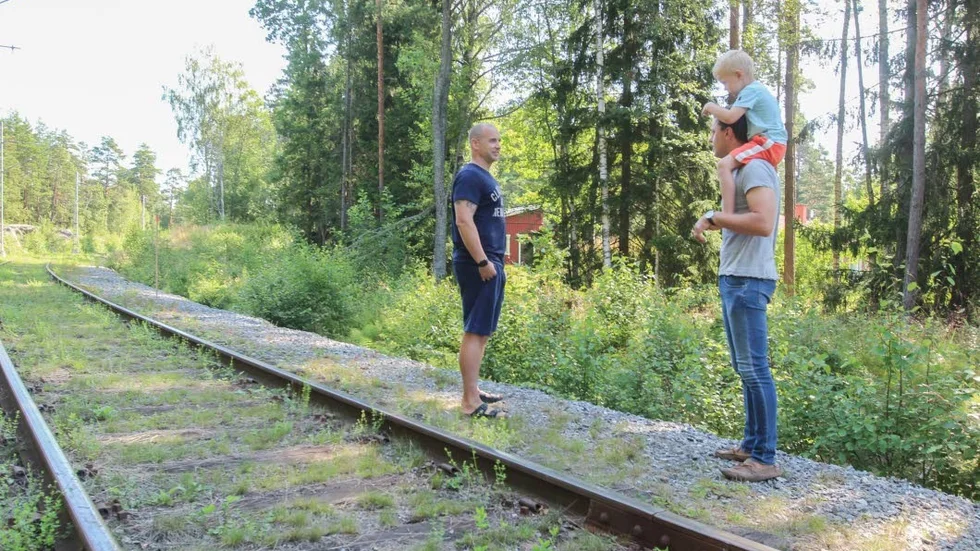 Christian Lindström och Per Skoglund, med sonen Ossian på axlarna, vid spåret som går intill deras grannskap. Huset i bakgrunden ligger bara några få meter från järnvägen.