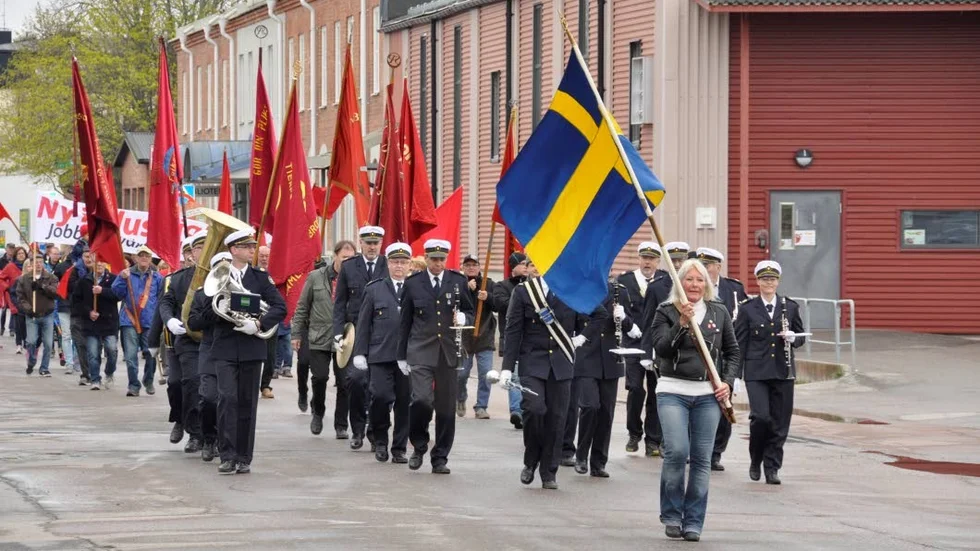 Barbro Wiklund bar den svenska flaggan vid S-tåget i Tierp.