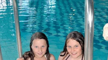 PREMIÄRBADARE. Tvillingarna Emma och Sara Wilhelmsson, 8 år, från Jokkmokk, premiärbadade dagen före den riktiga dopparedagen.
