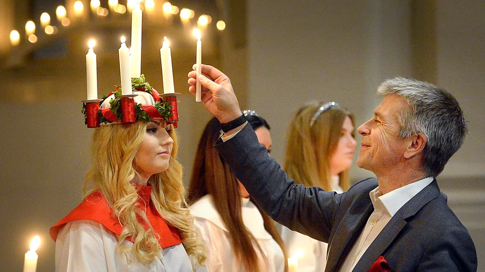 Kröning. Norrans vd Anders Westermark tänder ljusen på Felicia Åbergs luciakrona. Foto: Ulf Johansson.