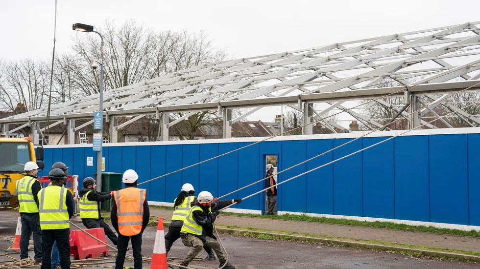 Byggarbetare sätter upp ett av de tillfälliga "ökningsnaven"' vid St Georges sjukhus i sydvästra London, med kapacitet för 100 sängliggande patienter.