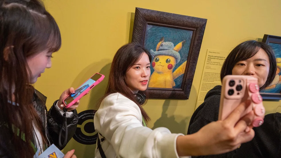 Besökare poserar framför en Pikachumålning på van Gogh-museet i Amsterdam.