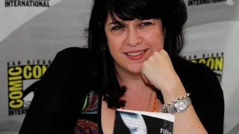 Author E.L. James poses with her book "Fifty Shades of Grey" at a book signing during the first day of Comic-Con convention held at the San Diego Convention Center on Thursday July 12, 2012, in San Diego.  (Photo by Denis Poroy/Invision/AP)