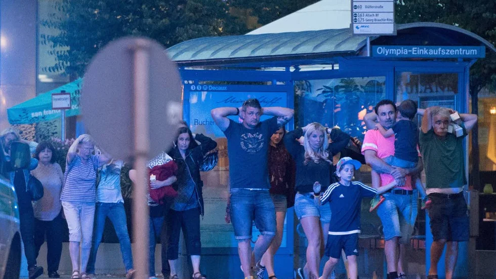 Munich. People leave the Olympia mall in Munich, southern Germany, Friday, July 22, 2016 after several people have been killed in a shooting. (AP Photo/Sebastian Widmann)
