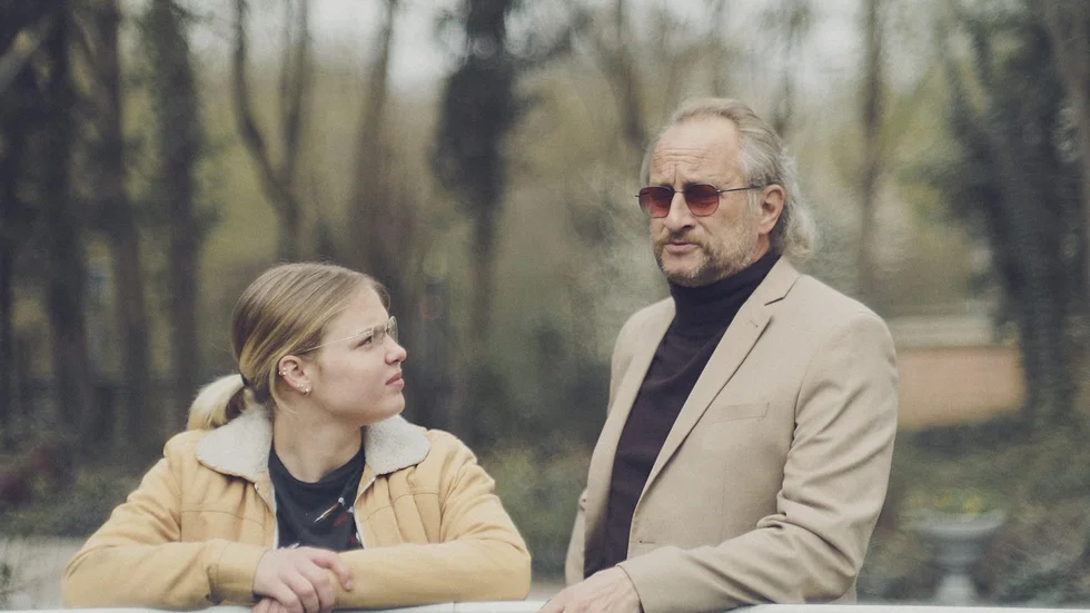 Lucie (Justine Lacroix) och hennes MS-sjuka pappa (Benoit Poelvoorde) försöker framstå som helt normala när socialen hälsar på.