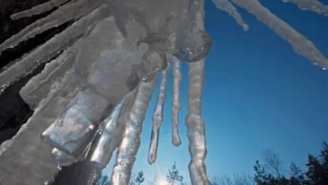 Icicles hang on a rock as the sun sinks in the west in the Thuringian Forest near Eisenach, central Germany, Wednesday, Feb. 1, 2012. A cold spell has reached central and eastern Europe with temperatures far below zero. (AP Photo/Jens Meyer)