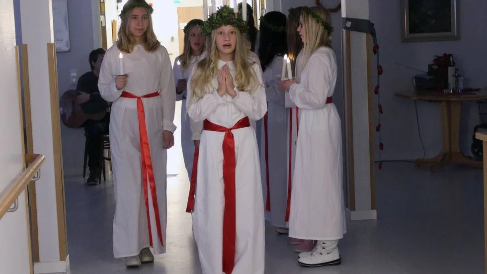 Lucia. Linnea Karlsson på väg ut med sina tärnor, efter att ha lussat på Ekhamra.