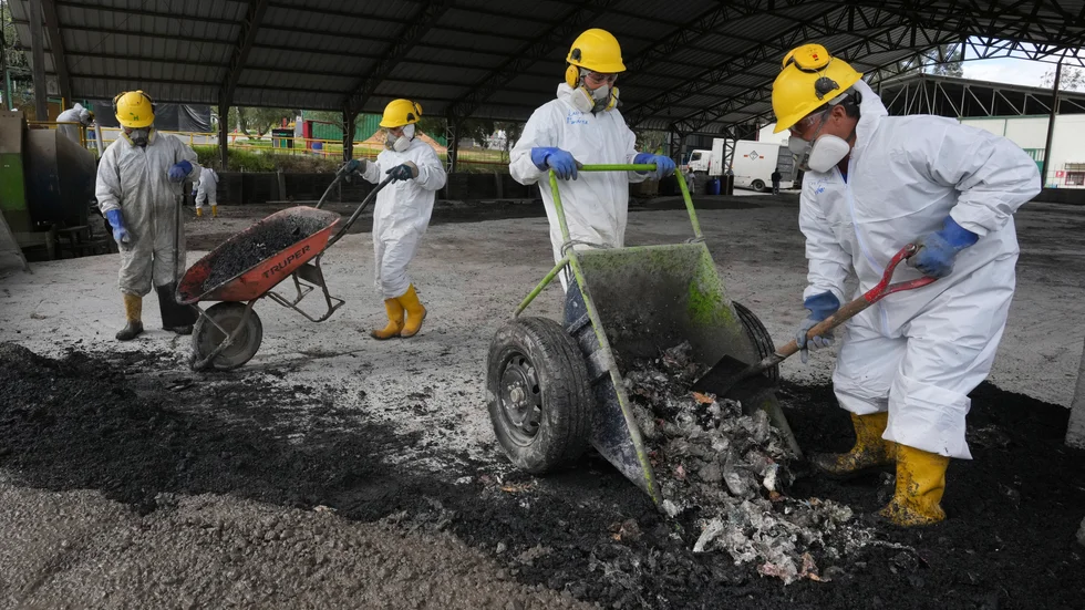Personal förstör beslagtagen narkotika som blandas med betong för beläggningsarbete i Ecuador. Arkivbild.