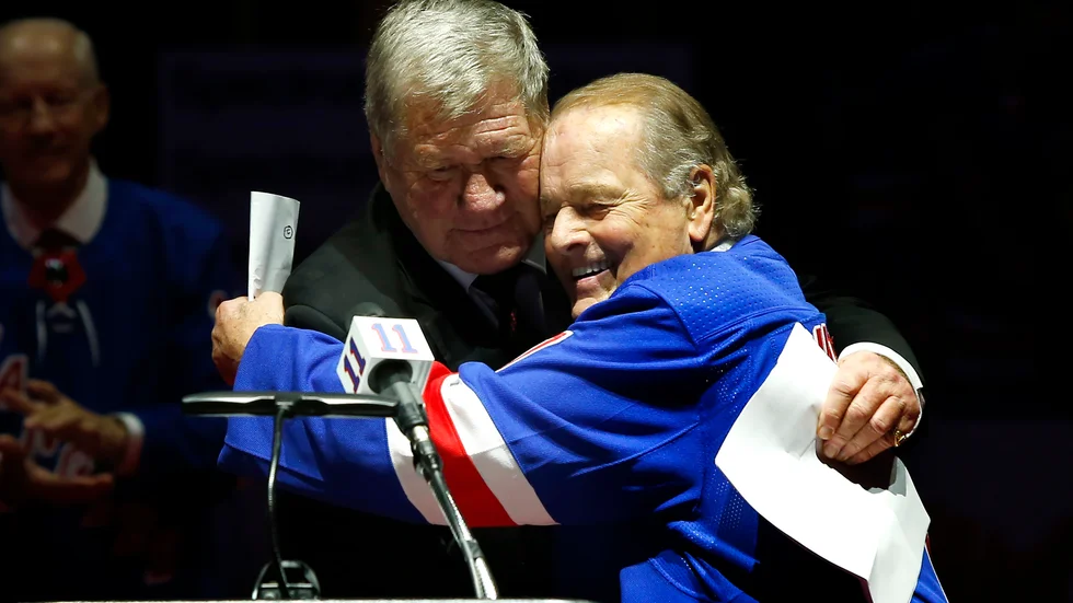 Rod Gilbert, till höger, omfamnar den tidigare Rangersspelaren Vic Hadfield. Arkivbild.