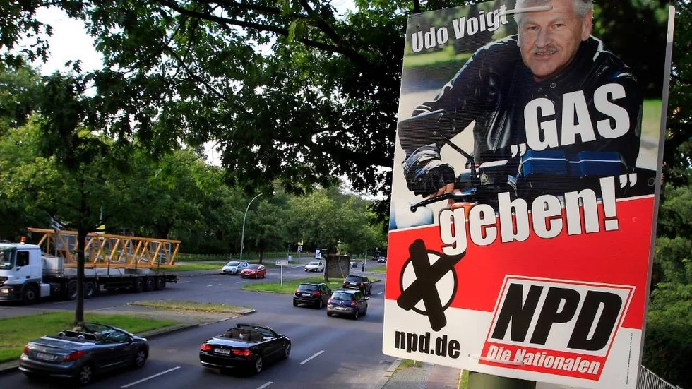 A election poster of the German right wing party NPD (National Party Germany) showing the party's chairman Udo Voigt and the slogan 'Gas geben!' (step on the gas!) is pictured in Berlin, Germany, Wednesday, Aug. 17, 2011. The German far-right party is drawing criticism for its regional election posters with the slogan "step on the gas" - picturing their leader on a motorcycle apparently revving the engine.  Martin Salm, head of the foundation that oversaw German compensation for Nazi-era slave laborers, said the signs appeared outside Berlin's Jewish Museum Wednesday. Given the Nazis' use of gas chambers in the murder of 6 million Jews, Salm says the slogan is "disgusting, provocative and intolerable."  (AP Photo/Michael Sohn)