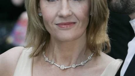 ** ADDS HUSBAND'S NAME ** British author of the Harry Potter series of books, JK Rowling poses for the photographers as she arrives with her husband Neil Murray for the premiere of the latest Harry Potter film, 'Harry Potter and the Order of the Phoenix', at a cinema in central London, Tuesday July 3, 2007.  (AP Photo/Lefteris Pitarakis)