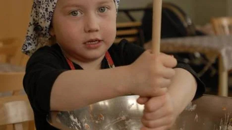 Tindra Tinderfjäll från femårsgruppen rör ihop matmuffins.