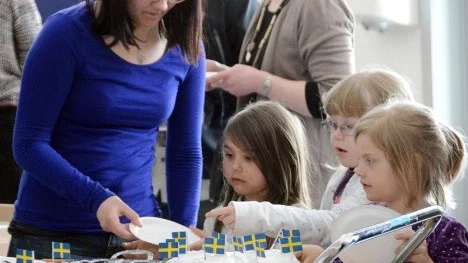 Amanda Alnqvist serverar eftertraktad tårta till förskoleeleverna.