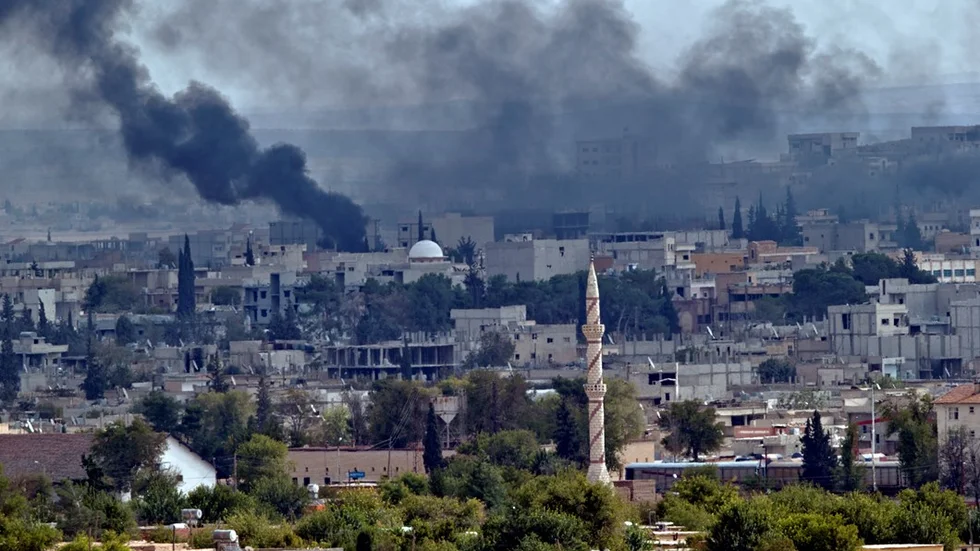 Smoke rises above the Syrian town of Kobani during fighting between Islamic State and Kurdish forces, seen from a hilltop on the outskirts of Suruc, Turkey, near the Turkey-Syria border, Sunday, Oct. 26, 2014. Kobani, also known as Ayn Arab, and its surrounding areas, has been under assault by extremists of the Islamic State group since mid-September and is being defended by Kurdish fighters. (AP Photo/Vadim Ghirda)