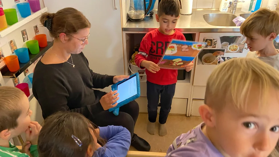 Fredagens bokashistund börjar med att barnen sjunger om Sigge Mask, som vill att barnen ska lägga ner mums i hans kompost. Pedagogen Li Dahlbacka leder sången och sedan ska fyraåriga Rafael Rasho, till höger om henne på denna bild, få tömma veckans fruktskal i hinken.