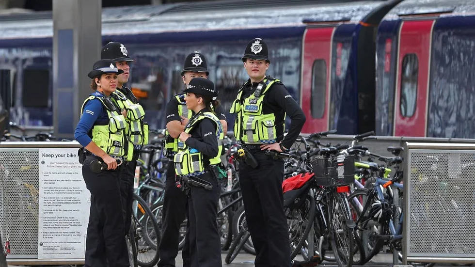 Police provide security at Paddington mainline train station in London, after a terrorist incident was declared at nearby  Parsons Green subway station Friday, Sept. 15, 2017. A bucket wrapped in an insulated bag caught fire on a packed London subway train early Friday, sending commuters running for safety at the height of the morning rush hour. (Andrew Matthews/PA via AP)