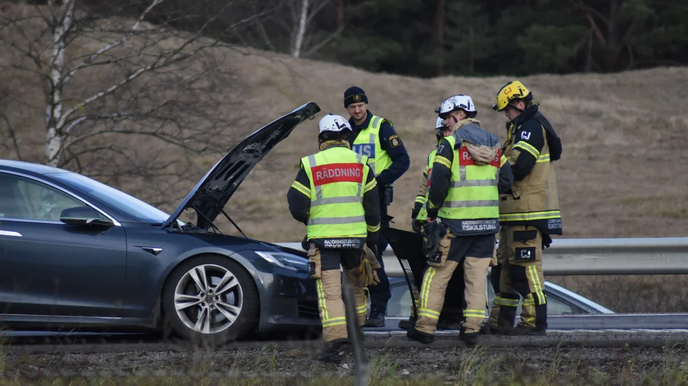 Polis och räddningstjänst undersöker den krockskadade bilen vid Årbyavfarten efter olyckan på E20.