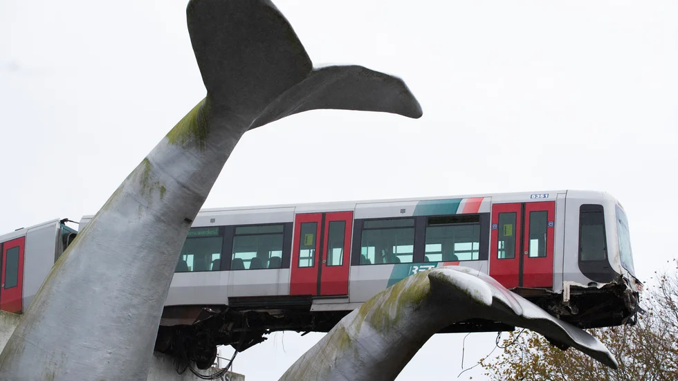 En tunnelbaneförare hade osannolik tur när hans urspårade tåg strandade på en gigantisk skulptur i Nederländerna.
