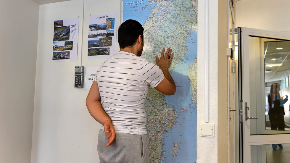 En man tittar på en Sverigekarta i 
Migrationsverkets anläggning i Märsta.






