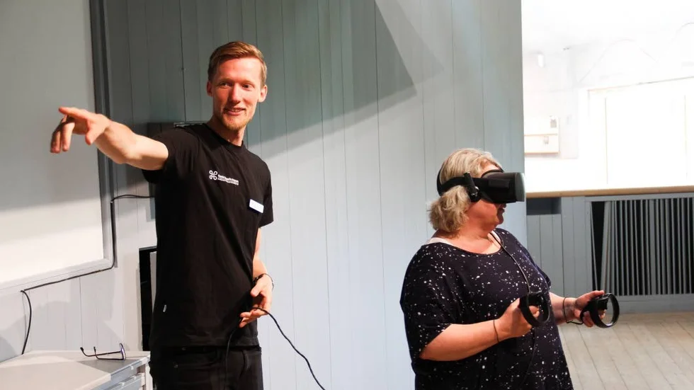Maximilian Hansen, museilärare och guide på Gamla Uppsala museum, visar Annica Strindin hur hon använder Virtual Reality.