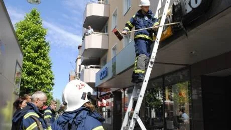 Brandmannen Erik Skoog undersöker den skadade skylten.Foto: Ingrid Johansson-Hjortvid