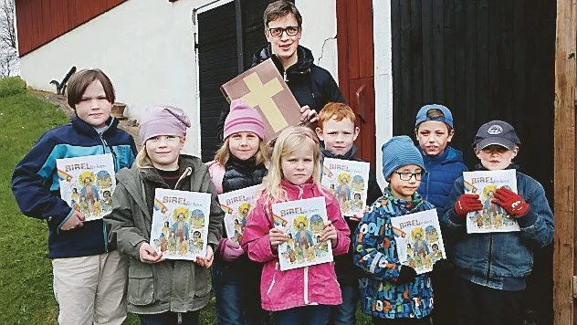 Pastorn Karl-Oskar Fredriksson med barnen som fick varsin ”Bibel för barn”.