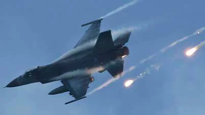 An F-16 drops chaff cartridges during the "Lien Yung" annual joint forces exercises in Pingtung County, southern Taiwan Thursday, June 7, 2012. (AP Photo/Wally Santana)