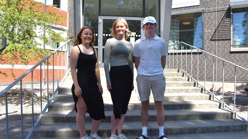 Än så länge är det lugnt vid trappan till entrén på Vimmerby Gymnasium. På fredag kommer Leoni, Myra och Hugo och många andra studenter springa ut härifrån med vita mössor på huvudet.