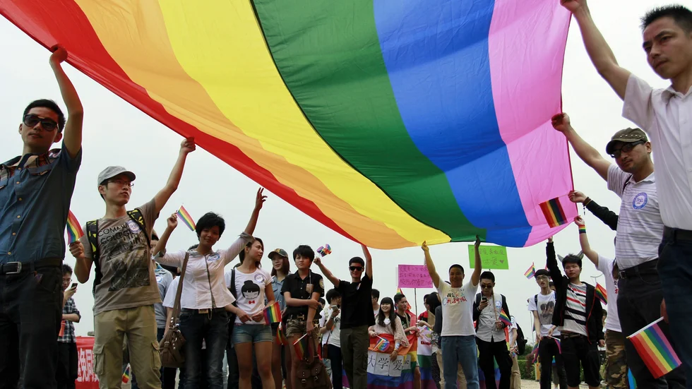 Hbtq-aktivister håller upp en regnbågsflagga i staden Changsha i södra Kina. Arkivbild.