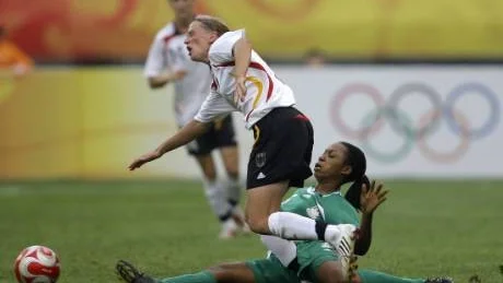 Tuff. Onome Ebi (grön), glidtacklar tyskan Kerstin Stegemann under OS i Peking 2008. Nu är hon aktuell som ny mittback i Piteås damallsvenska lag. Foto: Scanpix