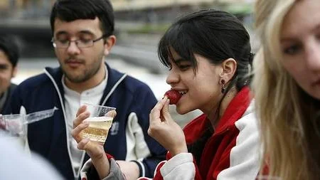 Angelica Delgado, utbytesstudent från Colombia, inmundigar traditionell Valborgsfrukost med jordgubbar och champagne.- I love Sweden, säger hon och skrattar.