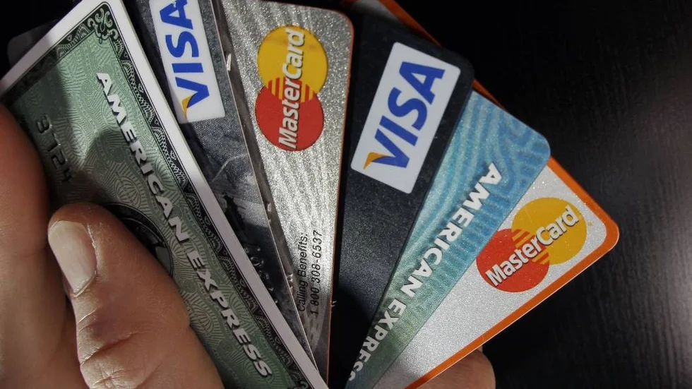 FILE - In this March 5, 2012, file photo, consumer credit cards are posed in North Andover, Mass. The three largest credit reporting agencies will change the way they handle records in a major revamp long sought by consumer advocates. The changes were announced Monday, March 9, 2015, after talks between Equifax, Experian, TransUnion and New York Attorney General Eric Schneiderman. (AP Photo/Elise Amendola, File)