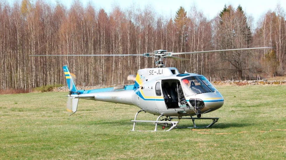 Helikoptern som hämtats in för att forsla bort de tunga ledningsstolparna i Fallstugorna utanför Motala.