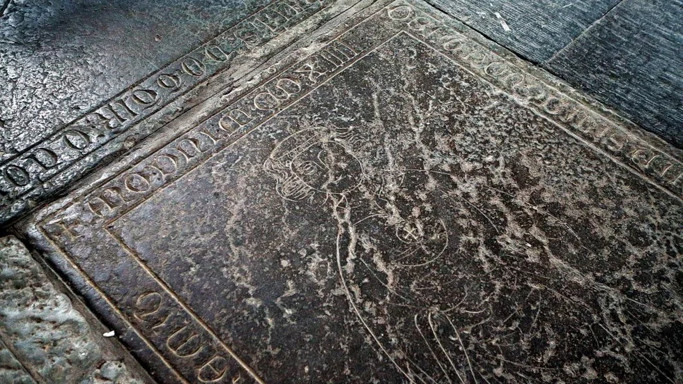 Stenen över prästen Erland Magnusson, en av många gravar i klosterkyrkan.