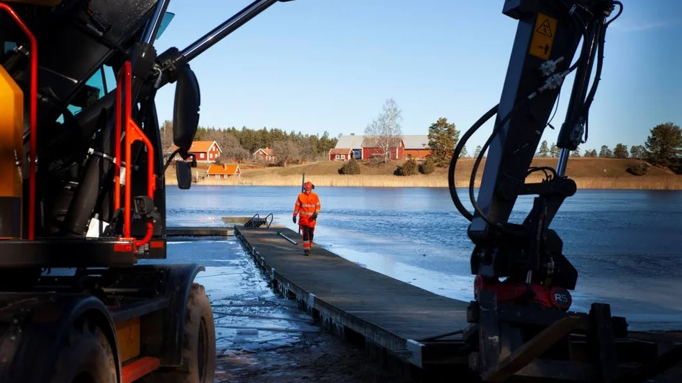 Bryggorna vid Skogsjöbadet fick hackas loss för hand innan de kunde dras upp. Senast 1 maj ska de nya bryggorna vara på plats.